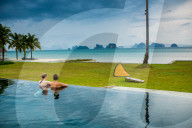 Couple relaxing in the pool on Koh Yao Noi Island in Thailand