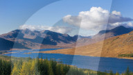 The road to the Scottish Highlands passing Loch Loyne and the distant mountains, Scotland, United Kingdom, Europe