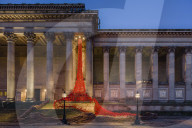The Poppies Weeping Window sculpture cascading down the St George's Hall building in Liverpool.