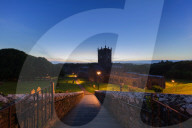 The historic St David's cathedral and Bishops Palace nestled in a natural valley at dusk in Pembrokeshire.