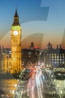 Big Ben, the Elizabeth Tower, and busy traffic on Westminster Bridge at dusk, London, England