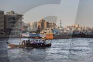 A water taxi carrying passengers crosses Dubai Creek, Dubai.