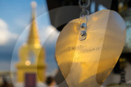Golden prayer flag etching with Buddhist gold stupa in background.