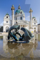 Karlskirche, St Charles Church, Karlsplatz, Vienna, Austria, Europe. Foreground the sculpture ‚ÄúHill Arches‚Äù by Henry Moore