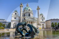 Karlskirche, St Charles Church, Karlsplatz, Vienna, Austria, Europe. Foreground sculpture ‚ÄúHill Arches‚Äù by Henry Moore