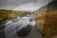 Iceland, Snaefellsness, National Park, Glacial river flowing through mossy tundra in Iceland