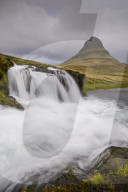 Rushing glacial run-off feeds Kirkjufellfoss on the Snaefellsness Peninsula, Iceland.