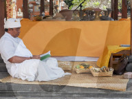 Man relaxing in a temple, Denpasar, Bali, Indonesia, Southeast Asia, Asia