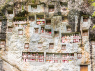 Galleries of tao-taos interspersed with the doors to family crypts. Tana Toraja, Sulawesi, Indonesia, Asia
