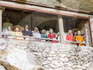 A gallery of tao-taos statues of ancestors) at a cliff gravesite. Tana Toraja, Sulawesi, Indonesia, Asia