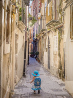 Little girl heading down a narrow Sicilian lane