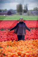 Young woman at tulip fields in Lisse, Netherlands