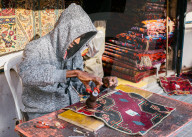 A man hand making a carpet in Tel Aviv, Israel