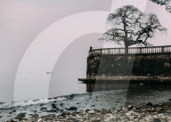 Unidentified woman looking at Lake Maggiore in Italy on a cold winter's day