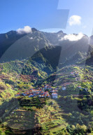 Elevated view of village and tree covered hills and mountains near Ponta Delgada