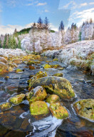 A winter view of the flowing water and colourful rocks of the River Polloch in the Ardnamurchan Peninsula, Scottish Highlands
