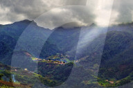 Elevated view of a remote village and tree covered hills and mountains near Sao Vicente