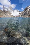 Stones seen through the water of Lago de los Tres featuring Monte Fitz Roy in the background, Patagonia, Argentina, South America