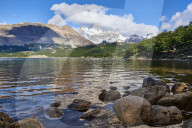 Wide angle shot of Capri Lagoon featuring Monte Fitz Roy in the background and rocks in the foreground, Patagonia, Argentina, South America