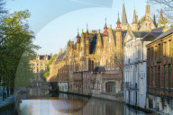 Houses and bridge reflection on Groenerei canal in the morning. Bruges, West Flanders province, Flemish region, Belgium.