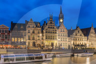 Belfry, houses and boats on Lys canal. Ghent, East Flanders province, Flemish region, Belgium.