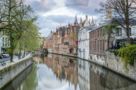 Houses and bridge reflection on Groenerei canal. Bruges, West Flanders province, Flemish region, Belgium.