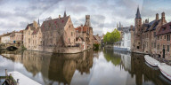 Houses reflection and boats on Dijver canal. Bruges, West Flanders province, Flemish region, Belgium.