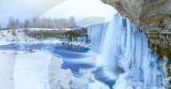 Winter ice covered and snowy waterfall, amazing site in Estonia
