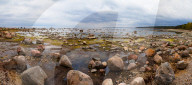 Baltic sea coast with granite boulders in cloudy day. Relaxing and cold landscape, wide panoramic view.