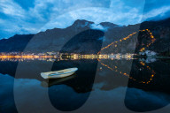 The UNESCO old town (stari grad) and fortress of Kotor reflected in Kotor Bay, Montenegro during the evening blue hour.