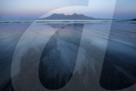 Pre sunrise colours and view to the Isle of Rum from the beach at Laig Bay, Isle of Eigg, Small Isles, Highlands, Scotland