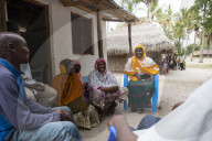 A group of women involved in a meeting about their village.
