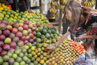 A VSO volunteer buying fresh fruit from a fruit stall on the side of the road in Addis Ababa, Ethiopia.