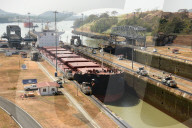 Electric 'mules' guiding Panamax ship through Miraflores Locks on the Panama Canal