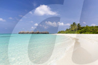 White sand beach, clear sea and over-water villas, Coco Palm, Dhuni Kolhu, Baa Atoll, Republic of Maldives, Indian Ocean