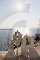 White church belltowers overlooking the Caldera, Oia, Santorini, Cyclades, Greece