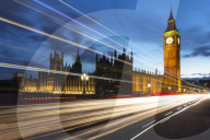 Big Ben and The Houses of Parliament at night with traffic trails on Westminster Bridge, London, England
