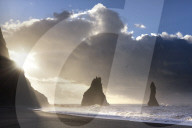 Rock stacks of Reynisdrangar in silhouette at sunrise, from Halsanefs Hellir Beach, near Vik Y Myrdal, South Iceland
