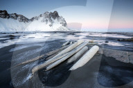 Frozen winter landscape at dusk with Vestrahorn mountains in distance, Stokksnes, South Iceland