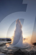 Strokkur Geysir erupting at sunrise during winter, geothermal area beside the HvÃ­tÃ¡ River, Geysir, Iceland