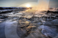 Hot pools and steam from Strokkur Geysir at sunrise, winter, at geothermal area beside the HvÃ­tÃ¡ River, Geysir, Iceland