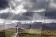 Ingjaldsholskirkja set against mountains on a dramatic stormy day, near Rif, Snaefellsnes Peninsula, Iceland