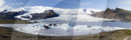 Panoramic view of tongue of the Vatnajokull Glacier creeping between mountains towards Fjallsarlon Lagoon, South Iceland