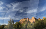 The ancient mud brick buildings of Kasbah Ait Benhaddou bathed in evening light, near Ouarzazate, Morocco