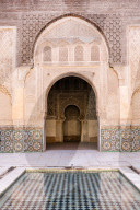 Wall of Ben Youssef Madrasa (ancient Islamic college) with reflection in pool of water, Marrakech, Morocco