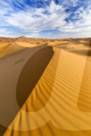 Wide angle view of the ripples and dunes of the Erg Chebbi Sand sea, part of the Sahara Desert near Merzouga, Morocco