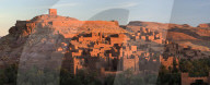 The ancient mud brick buildings of Kasbah Ait Benhaddou bathed in golden morning light, near Ouarzazate, Morocco