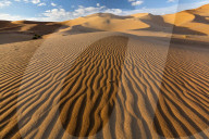 Wide angle view of the ripples and dunes of the Erg Chebbi Sand sea, part of the Sahara Desert near Merzouga, Morocco