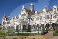 View from gardens to the imposing facade of Dunedin Railway Station, Anzac Square, Dunedin, Otago, South Island, New Zealand, Pacific