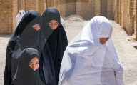 Different generations, different outlooks. Grandmother in much less common white chador and women and granddaughter in black ch